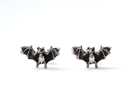 Bat-shaped earrings on a white background